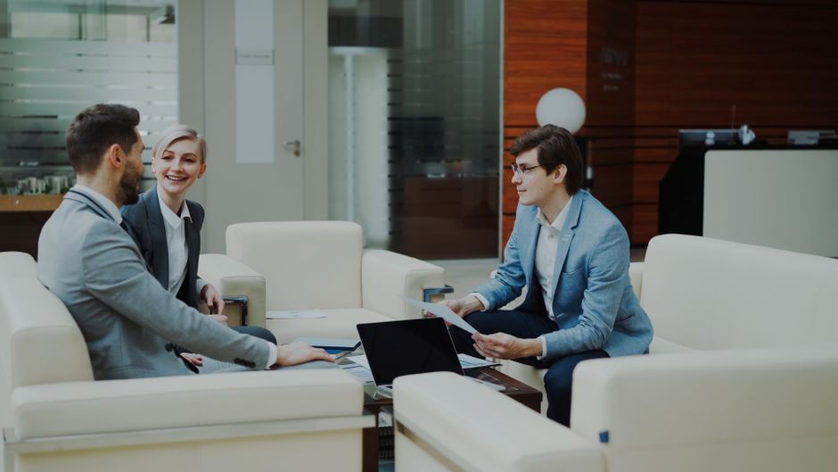 Group of professionals having a productive business meeting in a modern office setting.