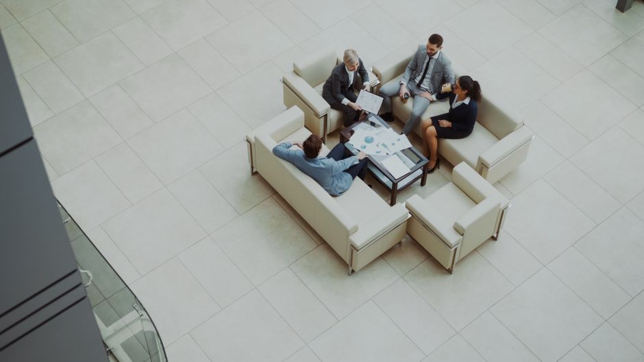 Aerial view of a group business meeting in a modern office setting.