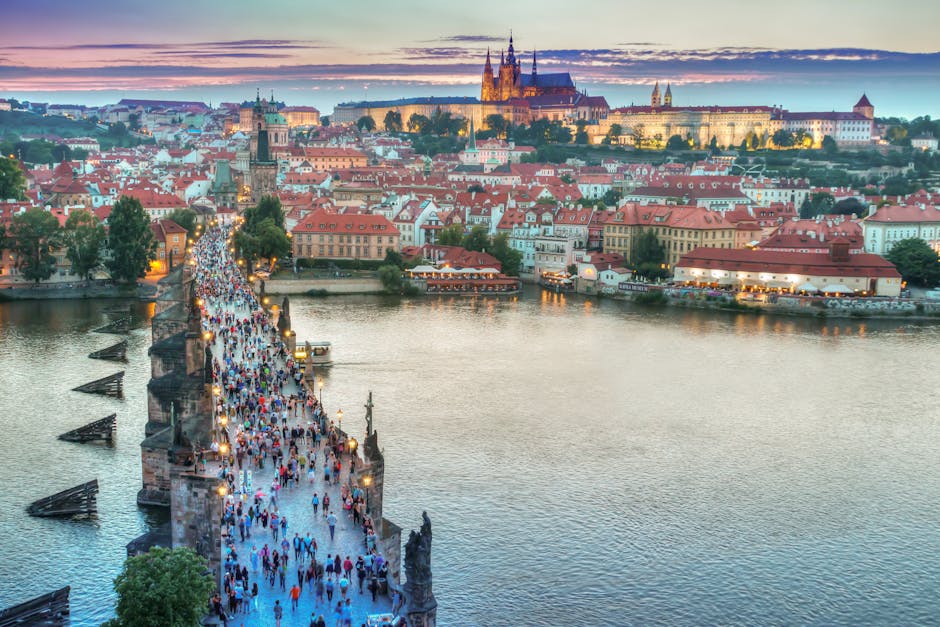A vibrant view of Charles Bridge leading to Prague Castle at sunset