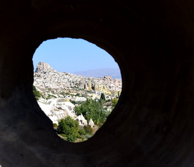 View of Cappadocia's unique rock formations through a cave opening